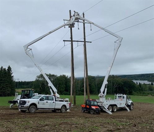 Versant Power crews working on poles