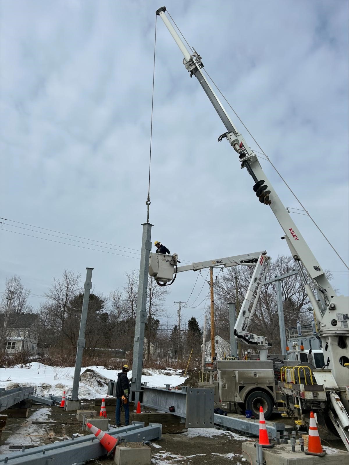 Power System Technicians Josh and Bryce stand up steel at the Orono substation