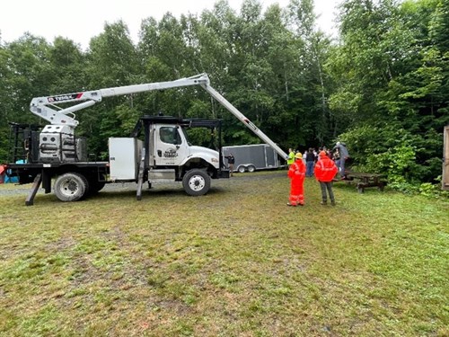 James Zuhlke, owner of Zuhlke Tree Service, shows students his bucket truck