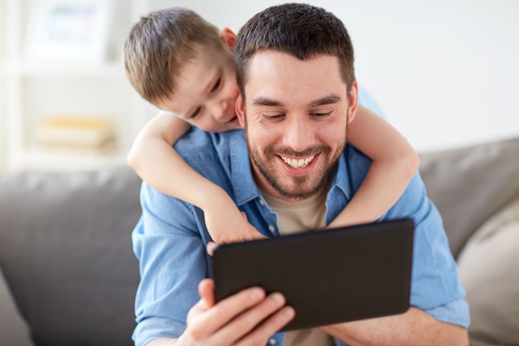 father and son looking at ipad