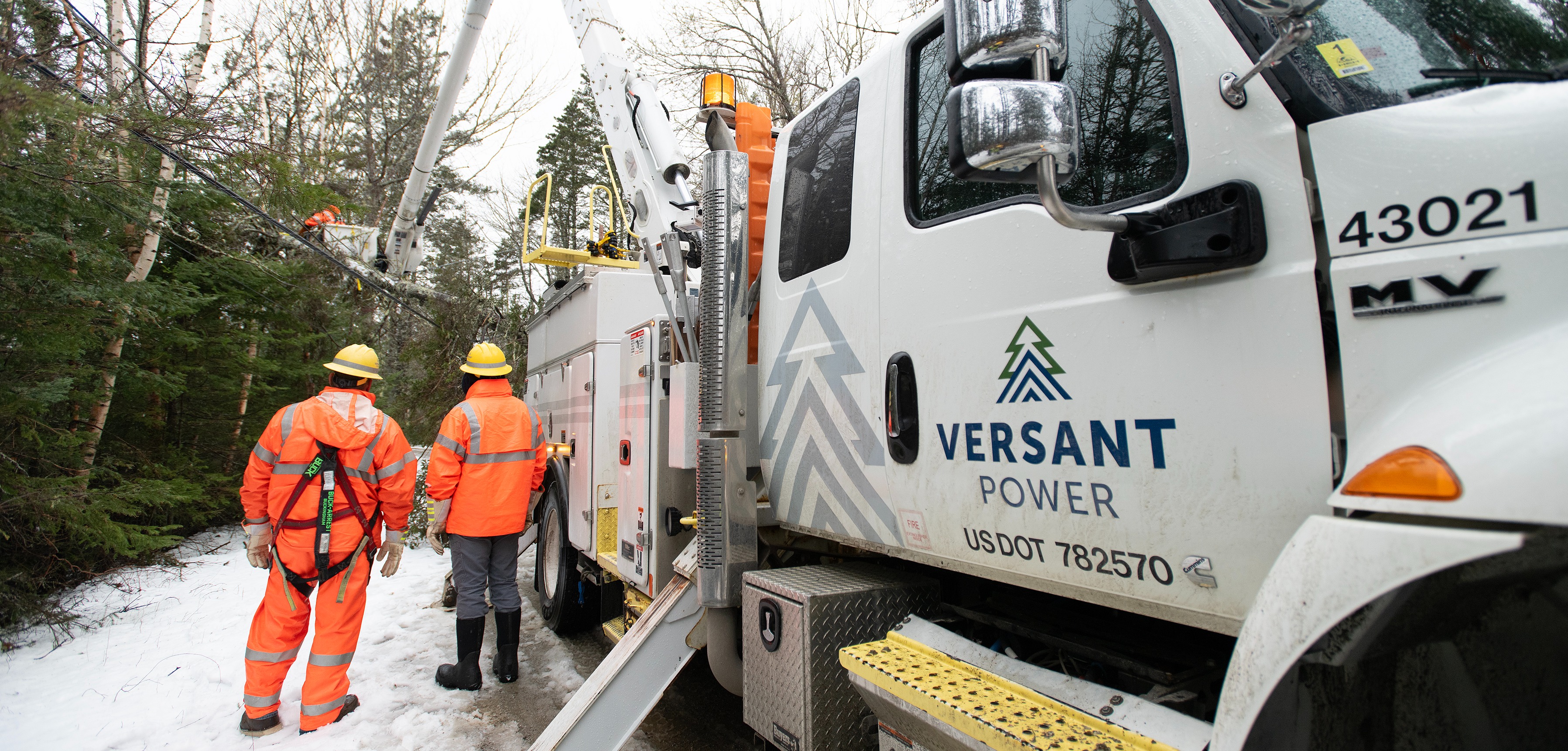 Truck and line men during snow storm